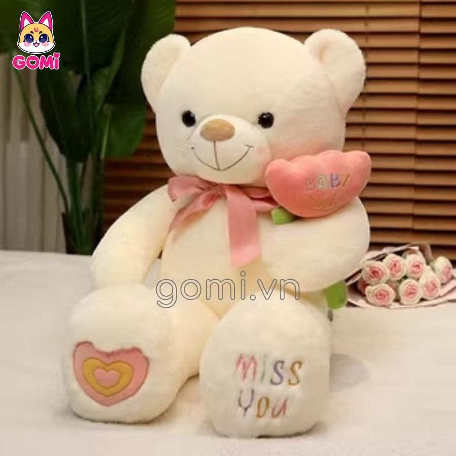 Gấu Bông Teddy Nơ Cầm Hoa Trắng