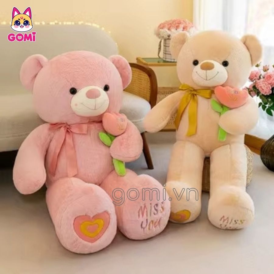 Gấu Bông Teddy Nơ Cầm Hoa Trắng